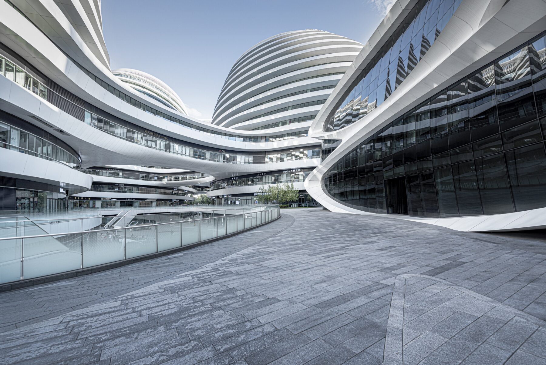 A sleek modern business district building featuring decorative stonework at the entrance